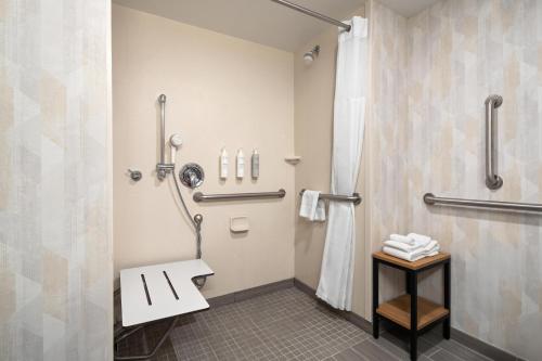 a bathroom with a shower and a sink at Hampton Inn Neptune in Neptune City