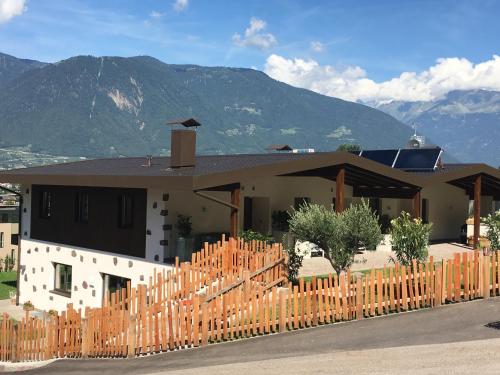 a house with a wooden fence in front of it at Moar Lodge in Postal