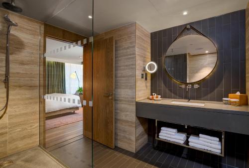 a bathroom with a sink and a mirror at Hilton London Bankside in London