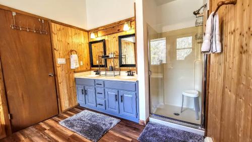 a bathroom with a sink and a shower at The Wooden Nest by AvantStay Deck Big Yard w Hammocks Fire Pit in Long Pond