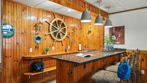 a kitchen with a wooden wall with a wooden wheel at Entertainers Home w Deck Game Room Hot Tub Lake View Retreat by AvantStay in Albrightsville