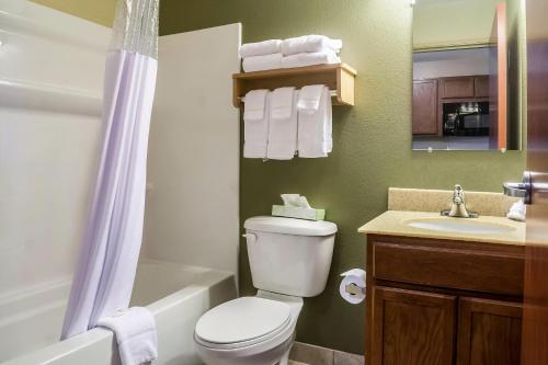 a bathroom with a toilet and a sink and a shower at Suburban Studios Triadelphia - Wheeling at The Highlands in Triadelphia