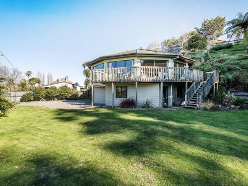 a large house with a deck and a yard at Private Rotorua Hideaway - Pet Friendly BB with Electric Heating in Mourea