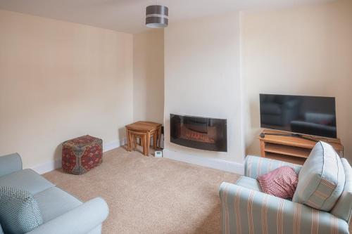 a living room with a couch and a fireplace at Town Centre Apartment Perfect Location with on-street parking in Stratford-upon-Avon