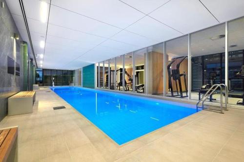 a large swimming pool in a building at Where Style Meets Convenience in Melbourne CBD in Melbourne