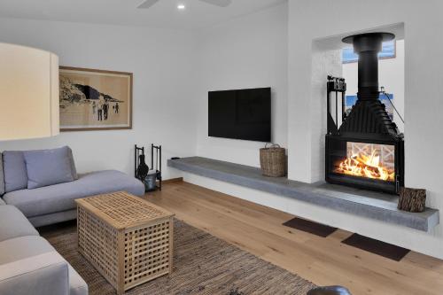 a living room with a fireplace and a couch at Eagle Rock - 400 meters to the beach in Aireys Inlet