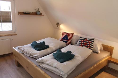 a bed with two pillows on it in a room at Boddenkahn in Born