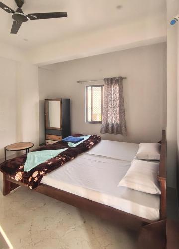 a large bed in a room with a window at Rajguru guest house in Pushkar