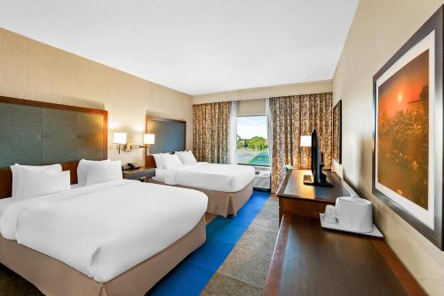 a hotel room with two beds and a desk at Quality Inn - Pratt in Pratt