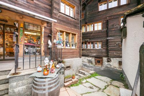 a building with a barrel in front of it at The Maisonette, the luxury edition in the center by Inspiring Places Zermatt in Zermatt