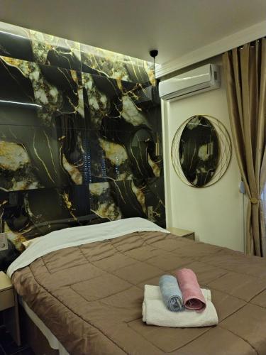 a bedroom with a bed with towels on it at Modern central apartment in Serres