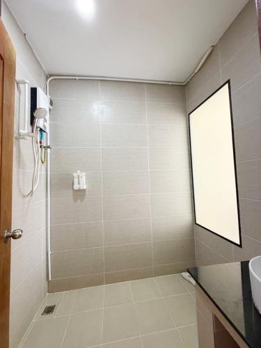 a bathroom with a shower with a glass door at O Mary River Resort in Sihanoukville