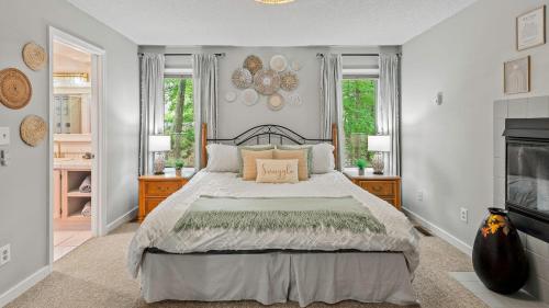 a bedroom with a large bed and two windows at The Boulder Inn by AvantStay Indoor Hot Tub Game Room Outdoor Fire Pit in Lake Harmony