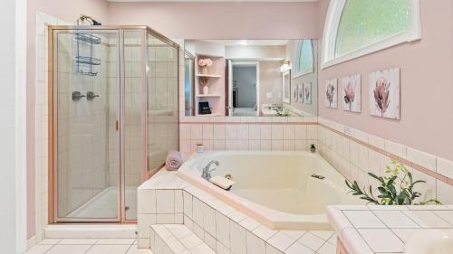 a white bathroom with a tub and a shower at The Boulder Inn by AvantStay Indoor Hot Tub Game Room Outdoor Fire Pit in Lake Harmony