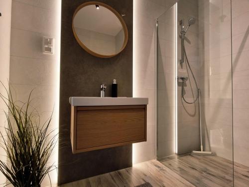 ein Badezimmer mit Waschbecken und Spiegel in der Unterkunft Apartamenty Łódź5-Piotrkowska 100m, Manufaktura 1km, Atlas-Arena, parking w budynku in Łódź