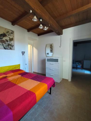 a bedroom with a colorful bed and a dresser at Casa 2C Amelia in Amelia