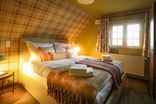 a bedroom with a bed with two towels on it at Haus Fasanenwiese 