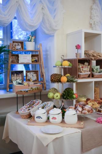 a table topped with lots of different types of food at Hotel Villa Erica in Grado