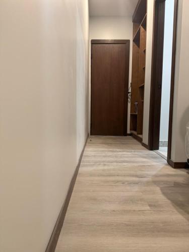 an empty hallway with a door and a floor at Hotel AlFari in Tijuana