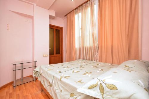 a bedroom with a bed and a window at Loft Apartment in the heart of Yerevan in Yerevan