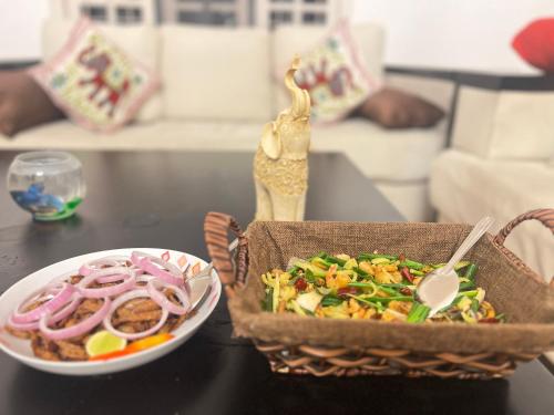 a table with a plate of food and a bowl of salad at Riverview Bentota in Bentota