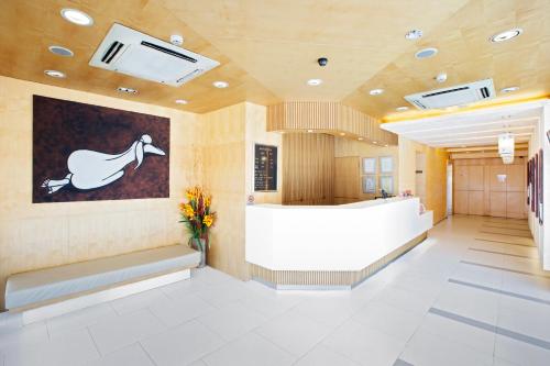 a lobby of a hospital with a horse painting on the wall at Hotel 81 Fuji in Singapore