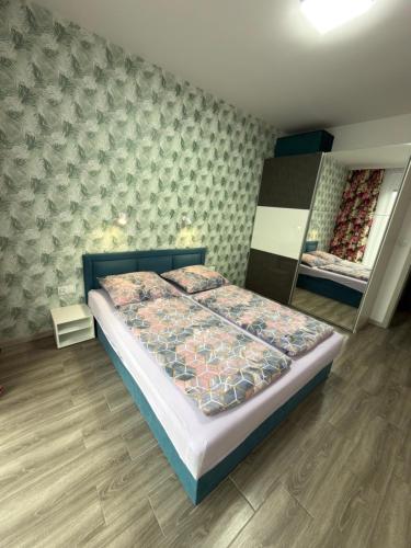a bedroom with a bed with a quilt on it at 1 Tyskie Apartamenty z prywatnym ogródkiem in Tychy