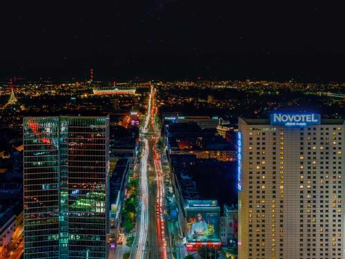 a view of a city at night with buildings at Novotel Warszawa Centrum in Warsaw