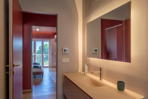 a bathroom with a sink and a mirror at Drea Acitrezza Luxury Home in Acitrezza