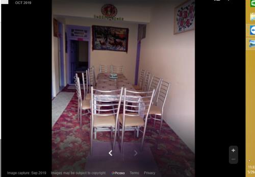 a dining room with a table and chairs at Malik Guest House in Dargai