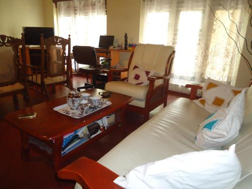 a living room with a couch and a table and chairs at Jayalath Homestay and Apartments in Galle