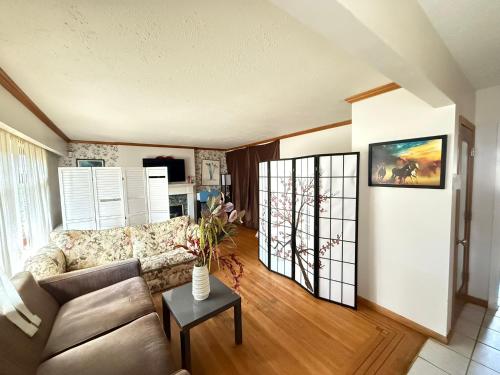 a living room with a couch and a table at Downtown Central City Cozy Private 2 Bedroom Basement Suite - Independent Entry in Surrey