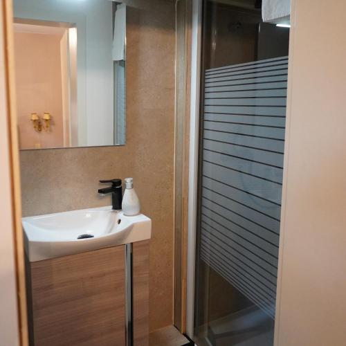 a bathroom with a sink and a shower at Villa Burgau in Monschau