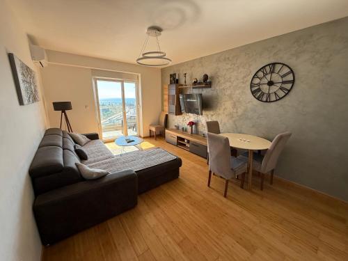 a living room with a couch and a table at Sea view apartment in Bar
