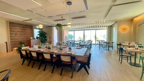 a large dining room with a long table and chairs at Opera Suite Hotel Pesaro in Pesaro