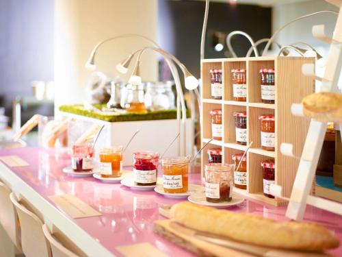 a table with jars of jam and bread on it at Novotel Monte-Carlo in Monte Carlo