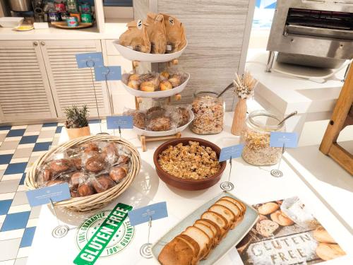 a table with different types of bread and pastries at Novotel Monte-Carlo in Monte Carlo