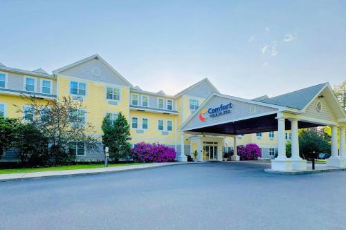 a large yellow building with a sign in front of it at Comfort Inn & Suites Scarborough-Portland in Scarborough
