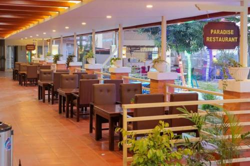 a restaurant with tables and chairs in a building at Paradise Hills in Bungmati