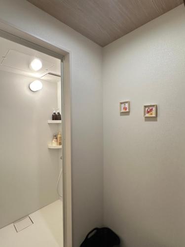 a bathroom with two pictures on the wall at snownuts 雪仁儿 in Hakuba