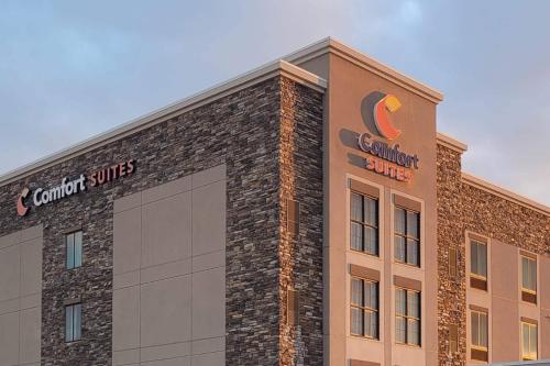 a building with a sign on the side of it at Comfort Suites Fargo Medical Center in Fargo