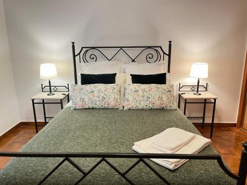 a bedroom with a large bed with two night stands at Granny's House by Trip2Portugal in Carvoeira
