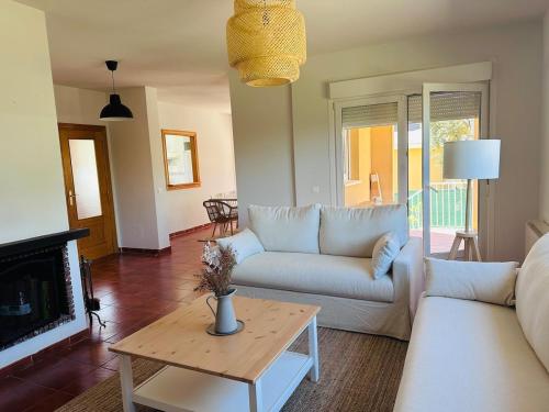 a living room with a couch and a table at Casa rústica en paraje natural in El Espinar