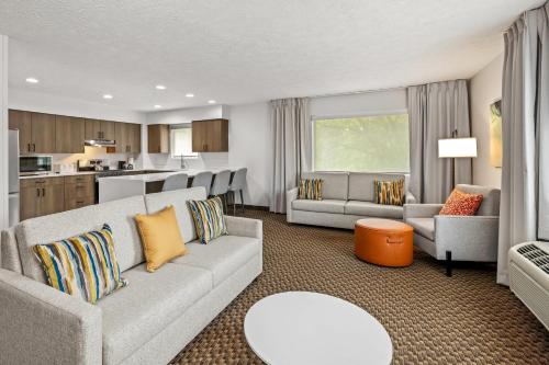 a living room with a couch and a kitchen at Comfort Inn Traverse City in Traverse City