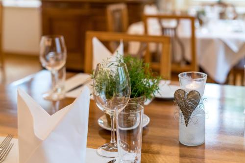 a table with two wine glasses on top of it at Linde Heiden Swiss Quality Hotel in Heiden