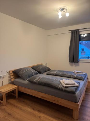 a large bed in a room with a window at Ski und Wander Ferienwohnung Galsterberg-Blick Pruggern - Schladming-Dachstein in Pruggern