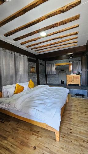 a large white bed in a room with a fireplace at The face resort in Muktināth