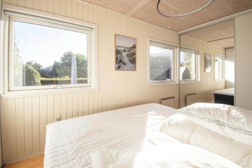 a bedroom with a bed and a window at Holiday Home With Sunset Views Near Hvidbjerg in Hvidbjerg