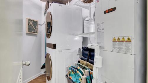a white refrigerator freezer in a room at 402 Summerhouse by AvantStay Beachfront Condo w Community Pool Access in Isle of Palms