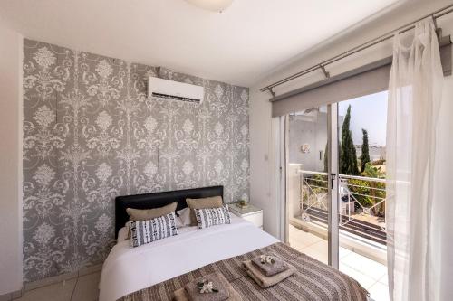 a bedroom with a large bed and a window at Nissini villa in Ayia Napa